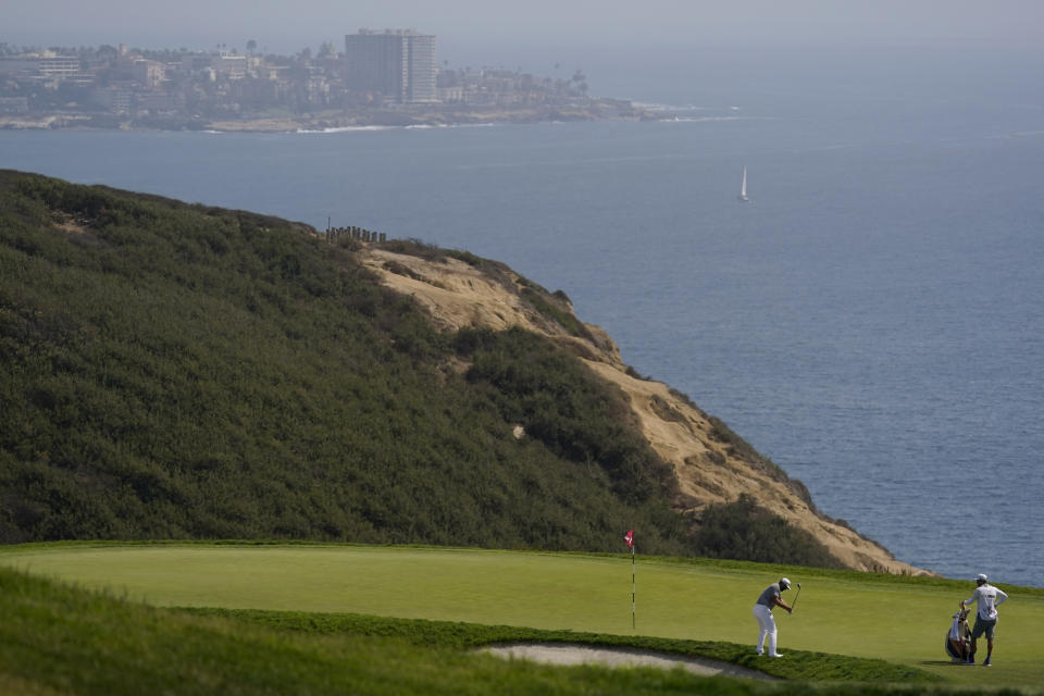 Dustin Johnson chips onto the third green during the first round of the U.S. Open Golf Championship, Thursday, June 17, 2021, at Torrey Pines Golf Course in San Diego. (AP Photo/Gregory Bull)