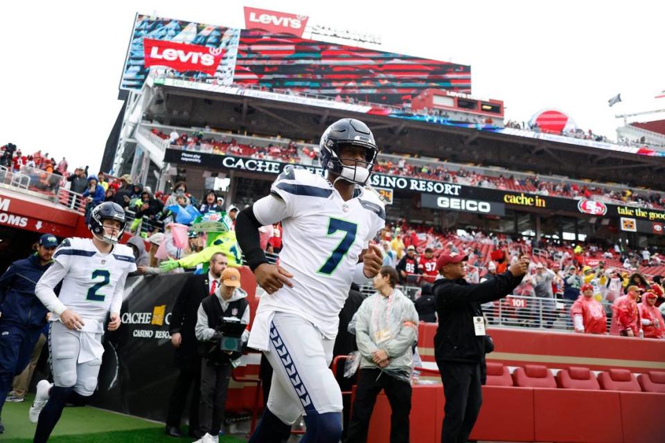 Seattle Seahawks quarterbacks Drew Lock (2) and Geno Smith (7) run onto the field before an NFL wild card playoff football game against the San Francisco 49ers in Santa Clara, Calif., Saturday, Jan. 14, 2023. (AP Photo/Jed Jacobsohn)