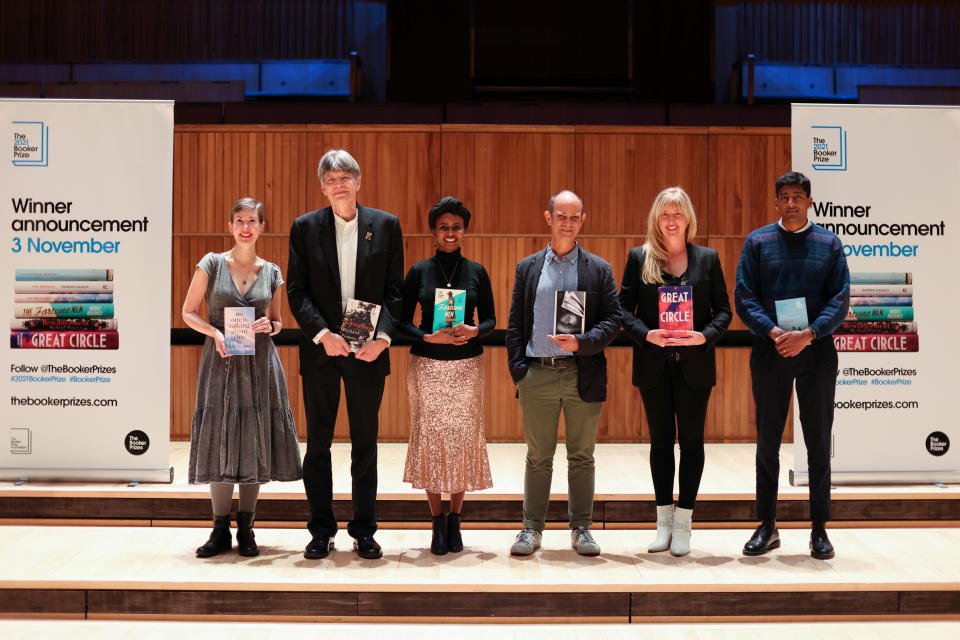 Booker Prize shortlisted fiction authors Patricia Lockwood, Richard Powers, Nadifa Mohamed, Damon Galgut, Maggie Shipstead, and Anuk Arudpragasam pose with their books, during a photo-call in London, Britain, October 31, 2021. REUTERS/Tom Nicholson