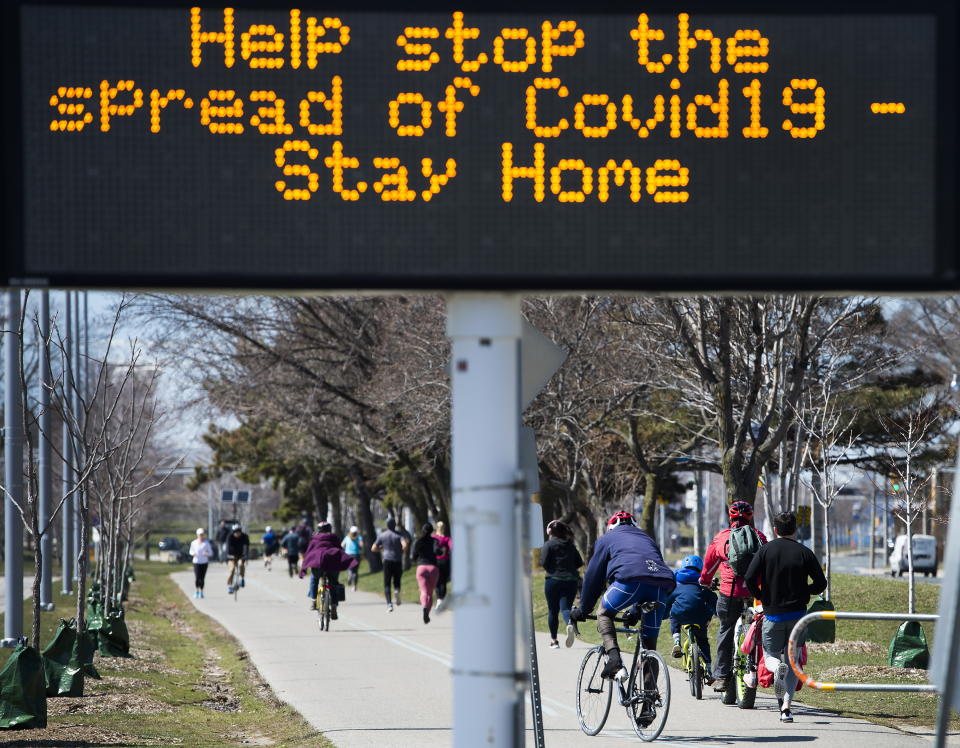 People get exercise outside on the lake shore path along Lake Ontario in Toronto on Thursday, April 2, 2020. Health officials and the government has asks that people stay inside to help curb the spread of the coronavirus also known as COVID-19. (Nathan Denette/The Canadian Press via AP)