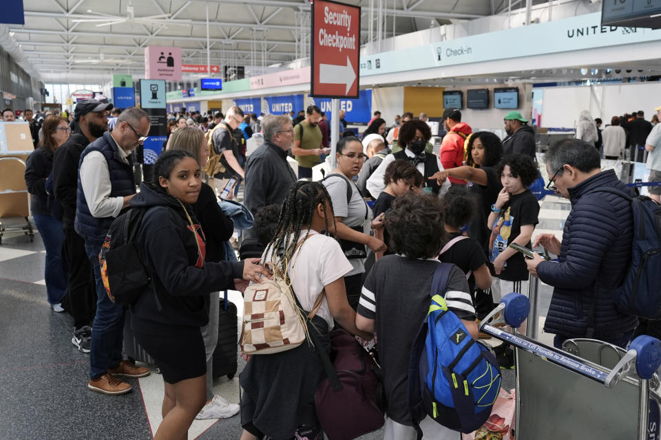 Passengers walk to a security checkpoint at O'Hare International Airport in Chicago, Monday, April 15, 2024. Pro-Palestinian demonstrators blocked a freeway leading to three Chicago O'Hare International Airport terminals Monday morning, temporarily stopping vehicle traffic into one of the nation's busiest airports and causing headaches for travelers. (AP Photo/Nam Y. Huh)