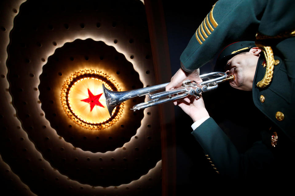 A military band member prepares for closing session