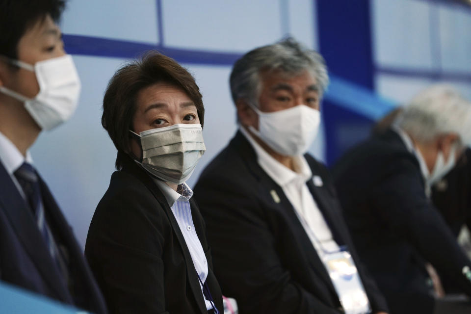 Tokyo 2020 Organizing Committee president Seiko Hashimoto observes the women's synchronized 3-meter springboard finals at the FINA Diving World Cup Saturday, May 1, 2021, at the Tokyo Aquatics Centre in Tokyo. (AP Photo/Eugene Hoshiko)