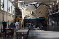 An employee works on a yacht at the Ferretti's shipyard in Sarnico, northern Italy, April 7, 2015. Picture taken on April 7, 2015. REUTERS/Stefano Rellandini