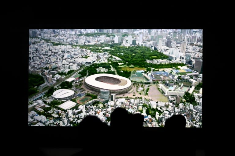 Attendants watch a computer-generated image of the new national stadium during its groundbreaking ceremony in Tokyo, in December 2016