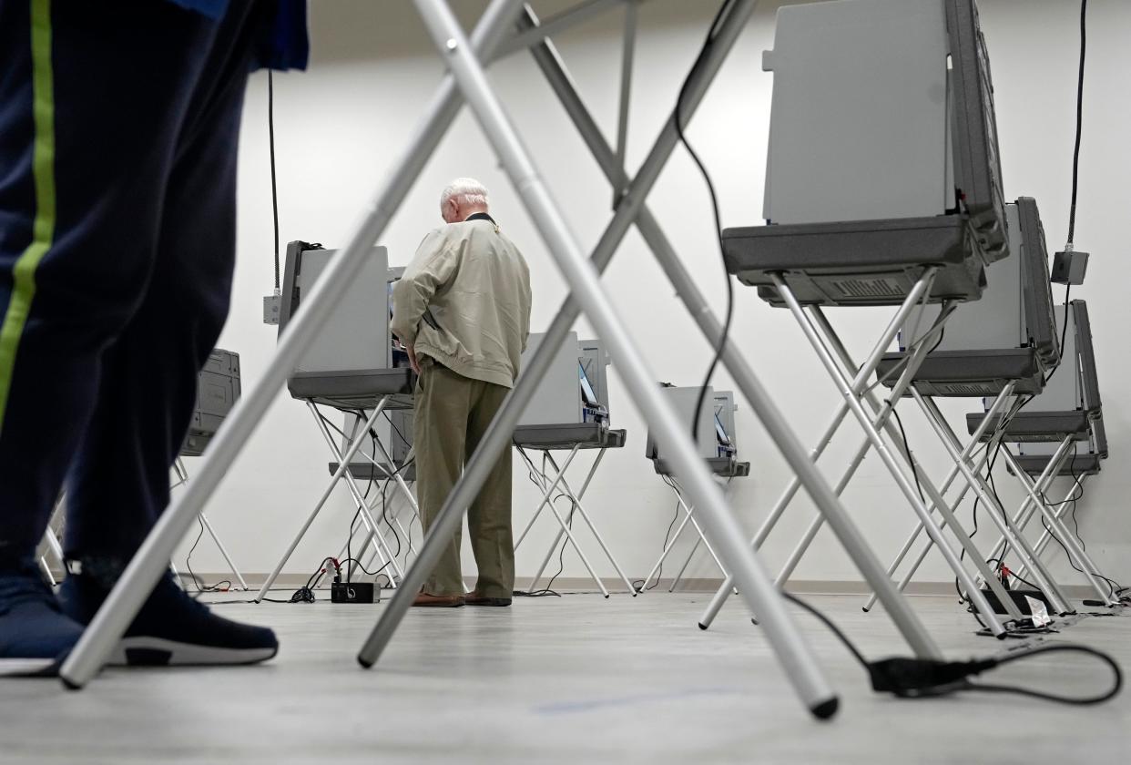 April 14, 2022; Delaware, Ohio, USA;  George Miller, 88, of Delaware, casts his ballot during early voting at the Delaware County Board of Elections. Mandatory Credit: Barbara J. Perenic/Columbus Dispatch