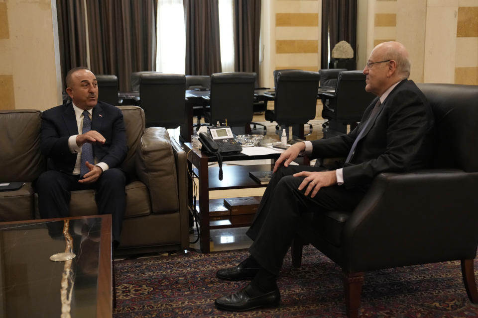 Turkey's Foreign Minister Mevlut Cavusoglu, left, meets with Lebanese Prime Minister Najib Mikati, at the government house in Beirut, Lebanon, Tuesday, Nov. 16, 2021. (AP Photo/Hassan Ammar)