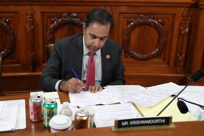 Rep. Raja Krishnamoorthi (D-IL) takes notes during a recess at a House Intelligence Committee hearing as part of the impeachment inquiry in Washington