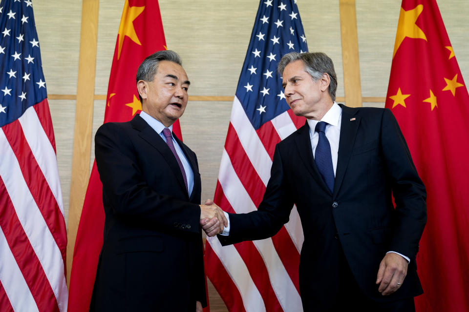 Chinese Foreign Affairs Minister Wang Yi shakes hands with Secretary of State Antony Blinken at a meeting on the Indonesian resort island of Bali in July 2022. (Stefani Reynolds / AP file)