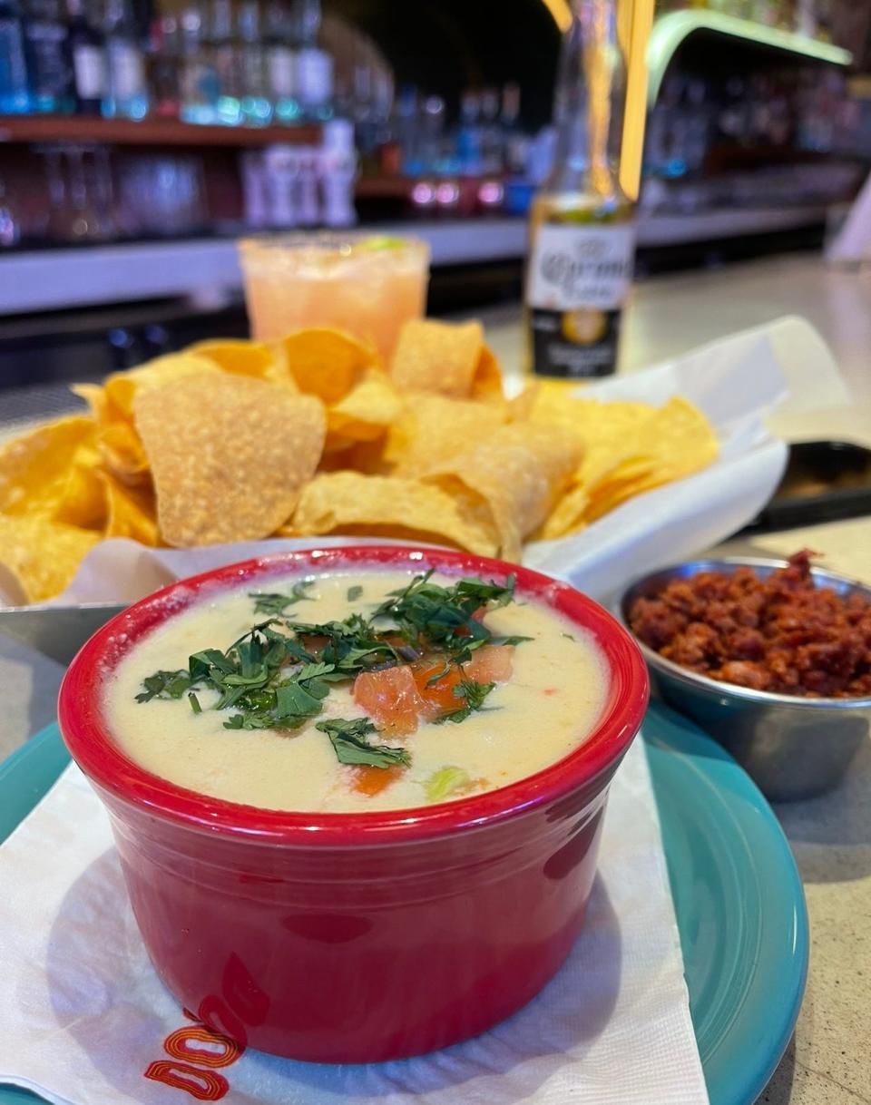 Tex mex queso with chips, chorizo and a Guava Coco Blossom margarita, with Santo Reposado Tequila, Coco Lopez Coconut Cream, guava purée, fresh lime juice, pineapple juice, agave nectar and toasted coconut flakes.