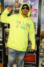 Nick Cannon raises a fist in a 'Fashion Junkie' hoodie at 99 Jamz Uncensored on Thursday in Fort Lauderdale, Florida.