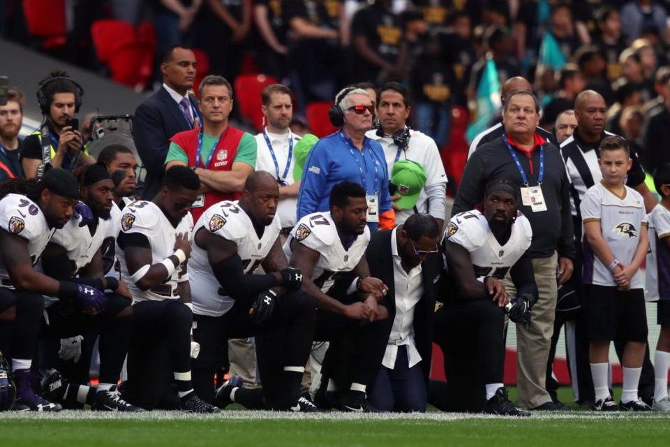 Players kneel in defiance of Donald Trump at Wembley Stadium ahead of an NFL International Series game (PA)