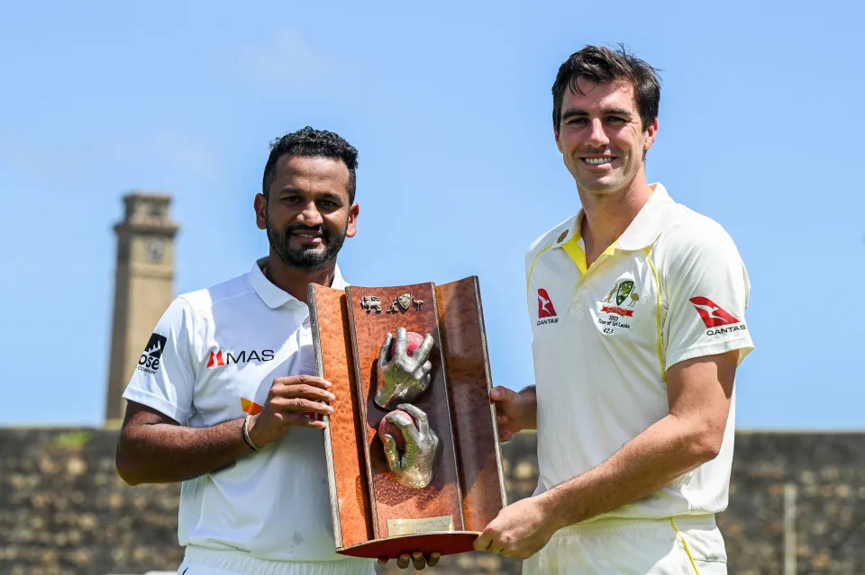 Dimuth Karunaratne and Pat Cummins, pictured here with the Warne-Muralitharan trophy at Galle International Cricket Stadium.