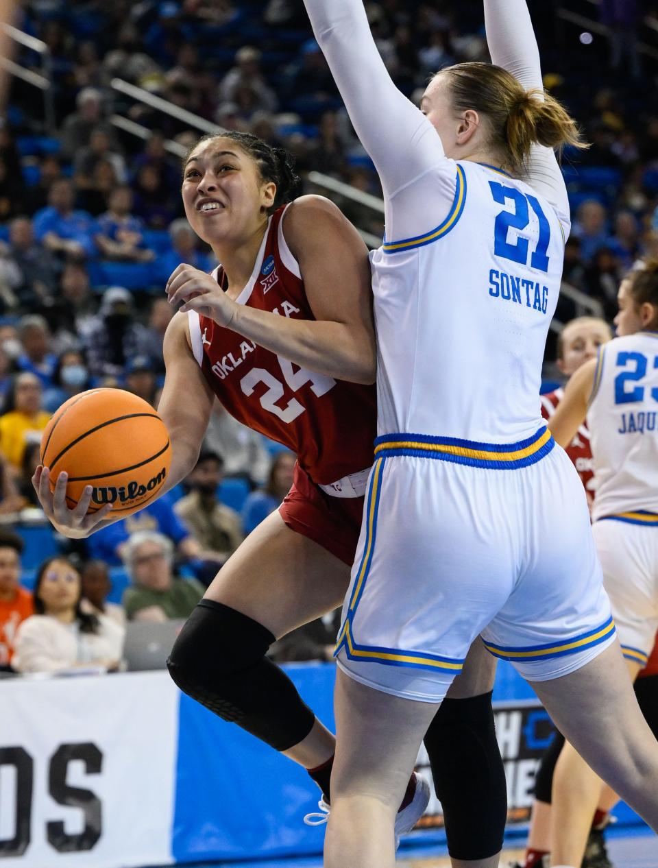 Mar 20, 2023; Los Angeles, CA, USA; Oklahoma Sooners guard Skylar Vann (24) drives to the basket as UCLA Bruins forward Lina Sontag (21) defends during the 2nd quarter of an NCAA Tournament Women’s 2nd Round dd game at Pauley Pavilion. Mandatory Credit: Robert Hanashiro-USA TODAY Sports