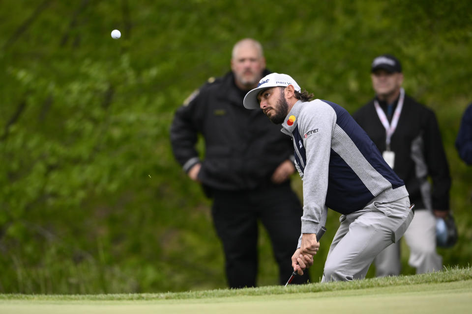 Max Homa chips to the green on the 12th hole during the final round of the Wells Fargo Championship golf tournament, Sunday, May 8, 2022, at TPC Potomac at Avenel Farm golf club in Potomac, Md. (AP Photo/Nick Wass)