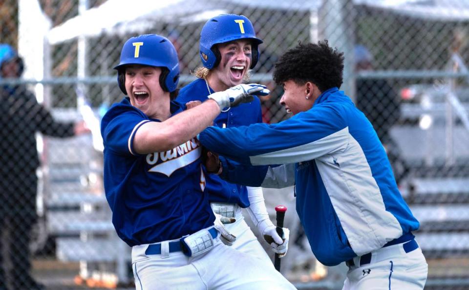 Tahoma’s Conrad Henkel (left) and Jack Dodge celebrate after scoring the game-trying runs in the sixth inning of Tuesday afternoon’s baseball game against the Federal Way Eagles at Federal Way High School in Federal Way, Washington, on Tuesday, April 18, 2023. Tahoma scored two more runs to win the game, 4-2.