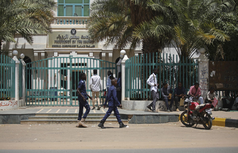 Sudanese soldiers walk in front of the office of the Sudanese Council of Ministers, in Khartoum, Sudan, Tuesday, Sept. 21, 2021. Sudanese authorities reported a coup attempt on Tuesday by a group of soldiers but said the attempt failed and that the military remains in control. The development underscored the fragility of Sudan's path to democracy, more than two years after the military's overthrow of longtime autocrat Omar al-Bashir amid a public uprising against his three-decade rule. (AP Photo/Marwan Ali)