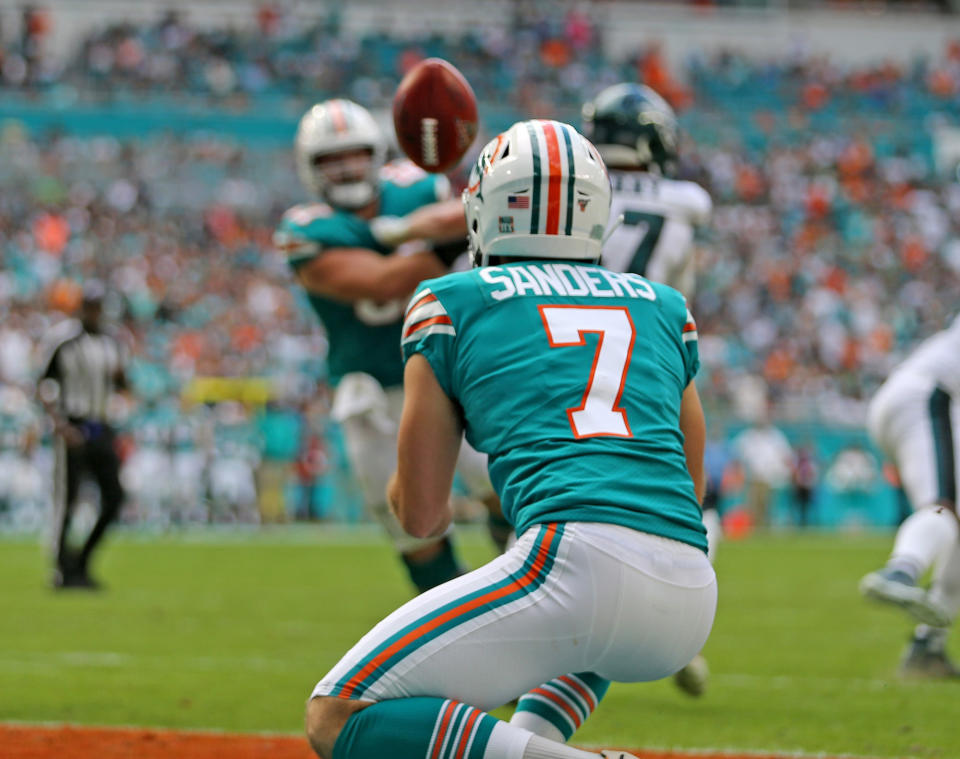 Miami Dolphins punter Matt Haack (2) tosses the ball to kicker Jason Sanders to score late in the second quarter as they play the Philadelphia Eagles at Hard Rock Stadium Sunday, Dec. 1, 2019 in Miami Gardens, Fla. The Dolphins won, 37-31. (Charles Trainor Jr./Miami Herald/Tribune News Service via Getty Images)