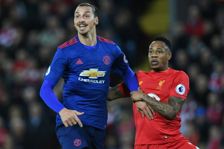 Manchester United's Zlatan Ibrahimovic (L) is marked by Liverpool's Nathaniel Clyne during the English Premier League football match at Anfield in Liverpool, north west England on October 17, 2016