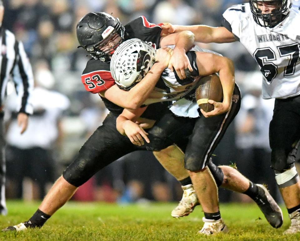 Machester’s Jadon Johnson (53) tackles Edison’s Talan McClurg (8) in the first half of Saturday’s game. (NICK CAMMETT/BEACON JOURNAL)