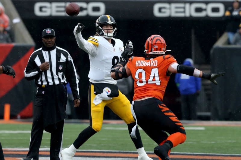 Pittsburgh Steelers quarterback Kenny Pickett (L) throws the football while under pressure from Cincinnati Bengals defensive end Sam Hubbard on Sunday at Paycor Stadium in Cincinnati. Photo by John Sommers II/UPI