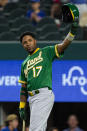 Oakland Athletics' Elvis Andrus (17) raises his helmet to spectators during the second inning of a baseball game against the Texas Rangers, Monday, June 21, 2021, in Arlington, Texas. (AP Photo/Sam Hodde)