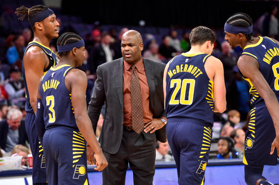 Indiana Pacers head coach Nate McMillan, center, talks with center Myles Turner (33), guard Aaron Holiday (3), and forwards Doug McDermott (20) and Justin Holiday (8) in the second half of an NBA basketball game against the Memphis Grizzlies, Monday, Dec. 2, 2019, in Memphis, Tenn. (AP Photo/Brandon Dill)