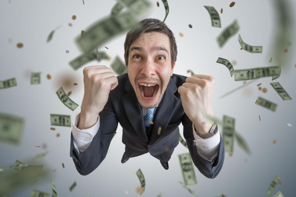 Man surrounded by falling money.