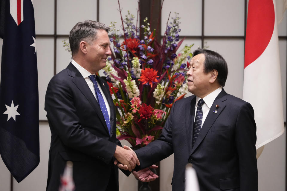 Australia's Defense Minister Richard Marles, left, shakes hands with Japan's Defense Minister Yasukazu Hamada as they pose for a photo before their talk at the Iikura guesthouse in Tokyo, Friday, Dec. 9, 2022. (AP Photo/Hiro Komae, Pool)