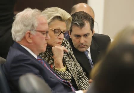 Defense attorney Andy Savage (L), assistant Cheryl Savage (C), look at a document with former North Charleston police officer Michael Slager at the Charleston County court in Charleston, South Carolina, December 5, 2016. REUTERS/Grace Beahm/Post and Courier/Pool