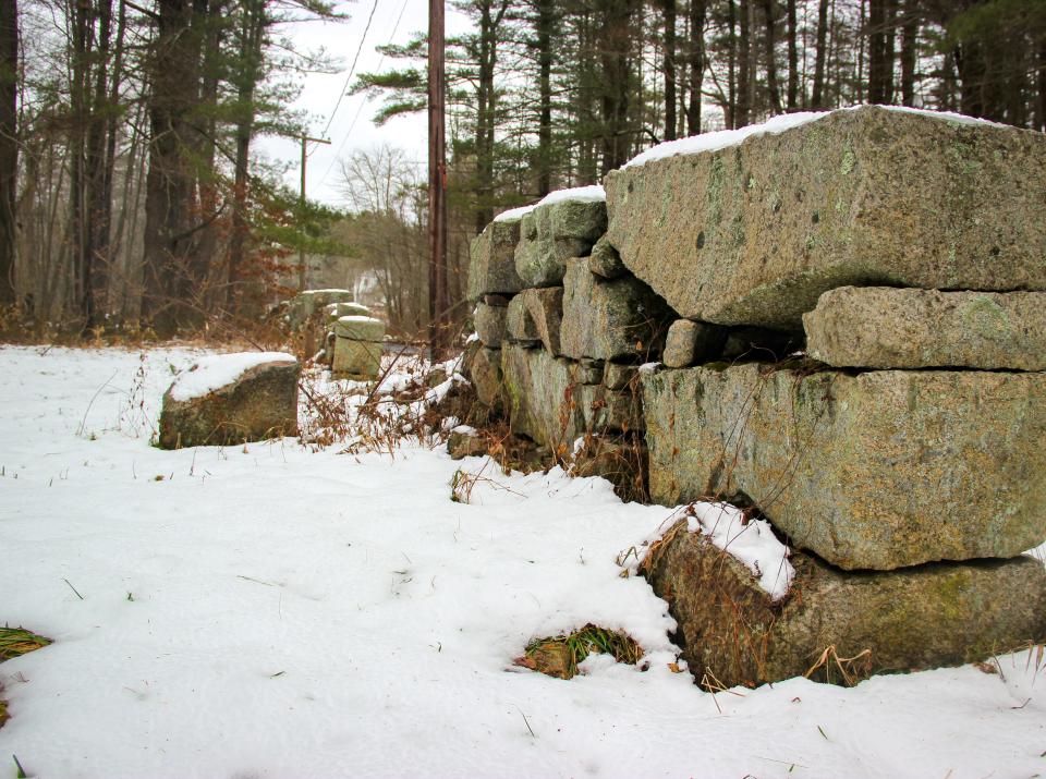 A stone wall is covered in a blanket of snow off Blossom Road in the Southeastern Massachusetts Bioreserve.