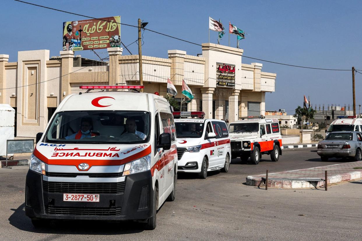 At least four Palestinian ambulances wait in a line. 