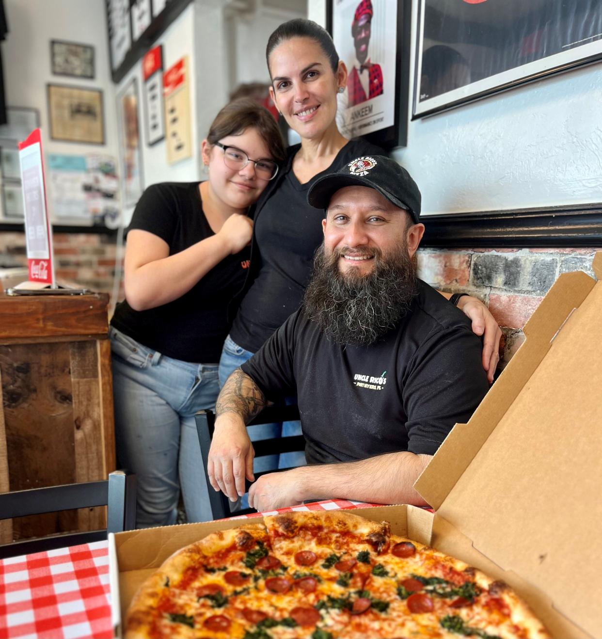 Enrico Aguila, pictured with his wife Cira and daughter Sarah, opened Uncle Rico's on March 22, 2022.