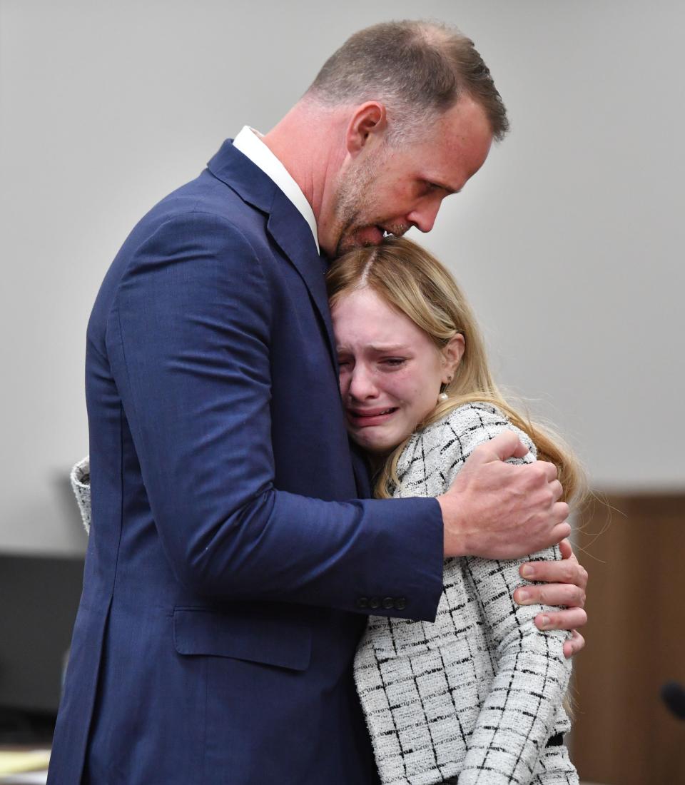 Maya Kowalski hugs her attorney Nick Whitney after a jury awarded her family more than $200 million on Thursday, Nov. 9, 2023. The Kowalski family sued Johns Hopkins All Children's Hospital for false imprisonment, negligent infliction of emotional distress, medical negligence, battery, and other claims more than a year after the family matriarch, Beata Kowalski, took her life following allegations she was abusing her daughter, Maya Kowalski.