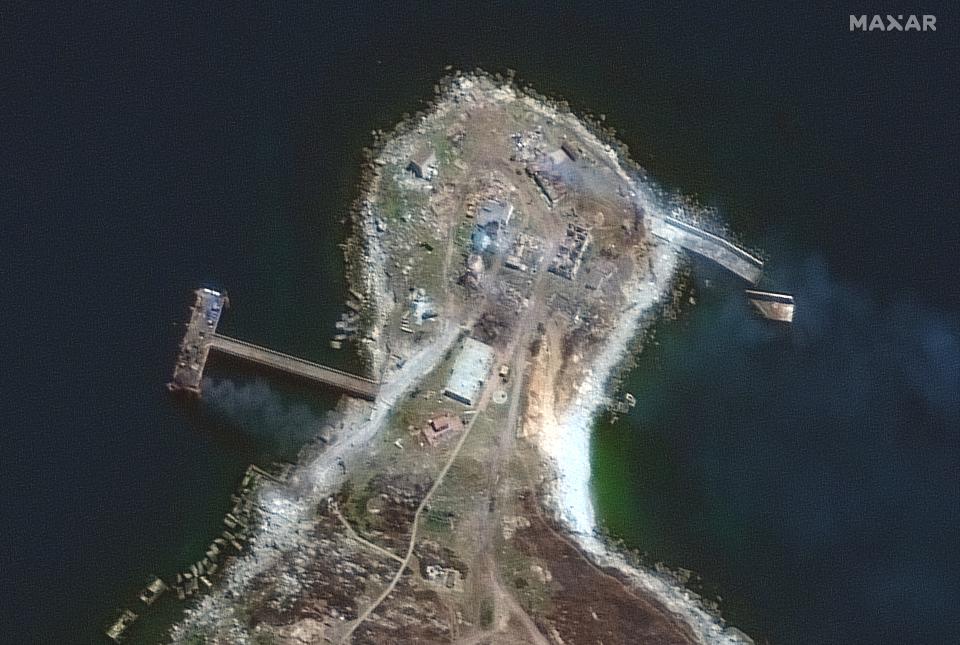 Closer view of northern end of island and burning pier and buildings on 30 June (Satellite image ©2022 Maxar Technologies.)