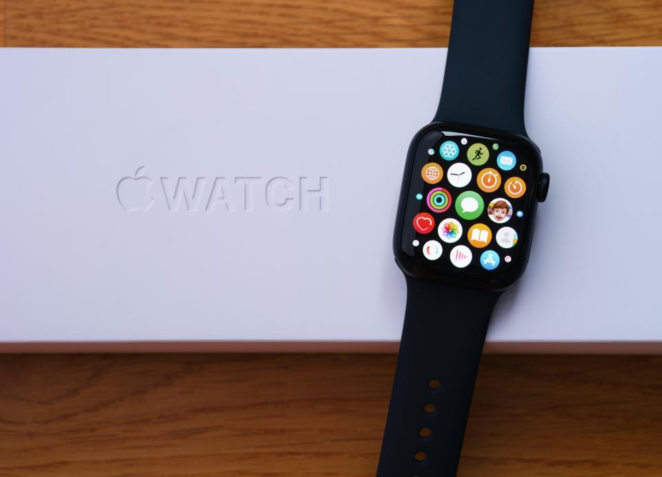 An Apple Watch series 7 with apps on its screen lying on its box (Alamy/PA)