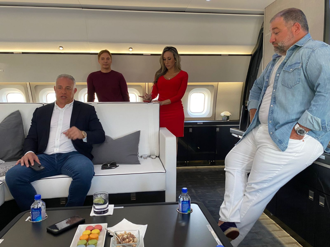 John H. Ruiz, left, with Ben Shirazi, right, and Diana Diaz, middle right, in the theater of his Boeing 767.