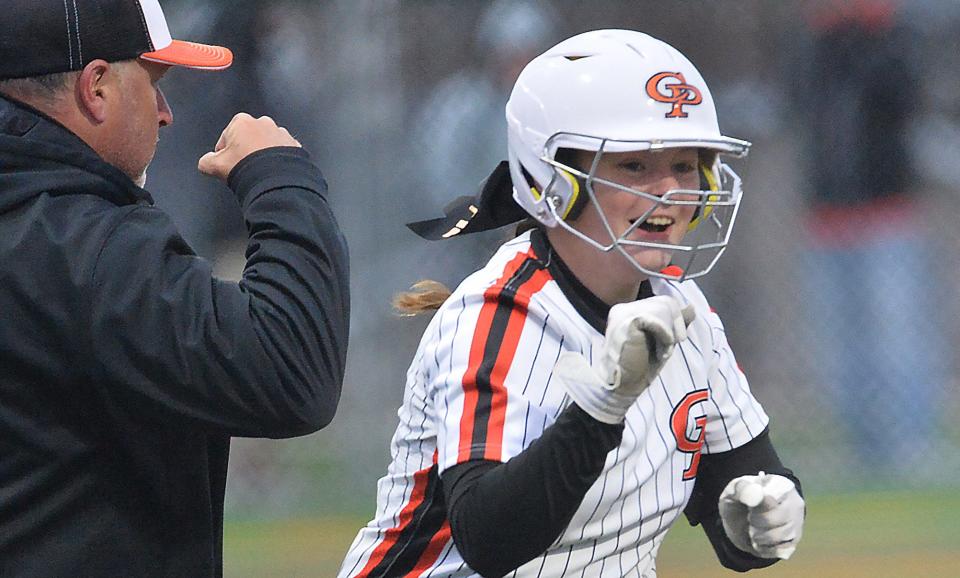 Cathedral Prep softball head coach Scott Baldi, left, congratulates junior Cam Chimera on her sixth-inning home run against McDowell at Mercyhurst University in Erie on April 18, 2023.