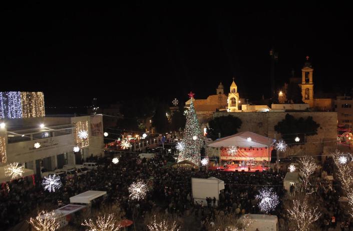 A view of Manger Square and the Church of the Nativity as people gather for Christmas eve celebrations in the biblical West Bank city of Bethlehem, believed to be the birthplace of Jesus Christ, on December 24, 2014 (AFP Photo/Ahmad Gharabli)