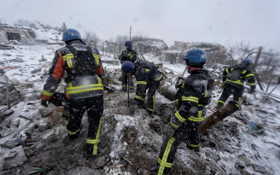 Ukrainian firemen remove rubble from the site of a Russian missile strike in Pokrovsk, Donetsk