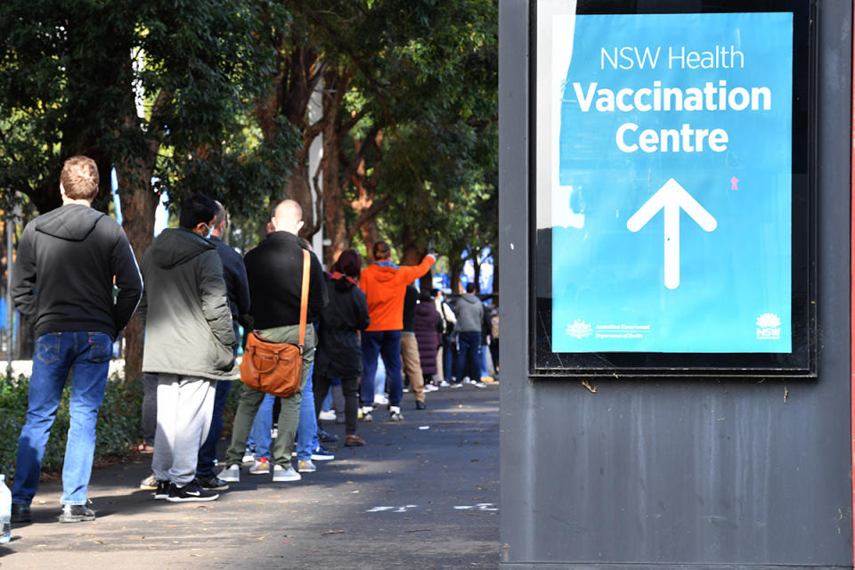 People are seen queued to receive their vaccination at the NSW Vaccine Centre at Homebush Olympic Park on Thursday