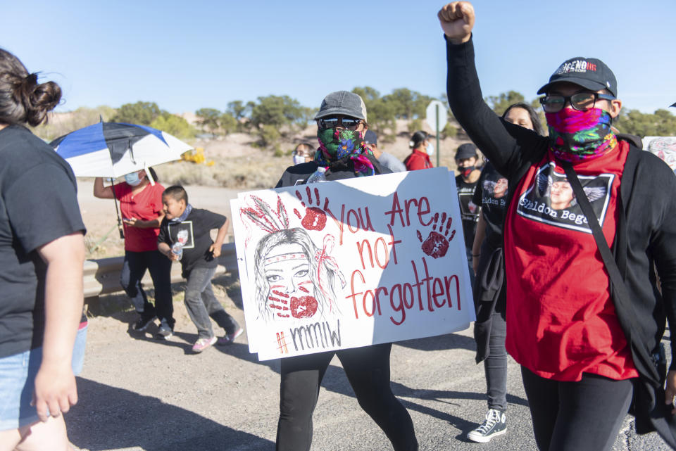 In this image provided by the Navajo Nation Office of the Speaker, family members and advocates participating in a walk on the Navajo Nation, Wednesday, May 5, 2021, near Window Rock, Ariz., to commemorate a day of awareness for the crisis of violence against Indigenous women and children. (Byron C. Shorty, Navajo Nation Office of the Speaker via AP)