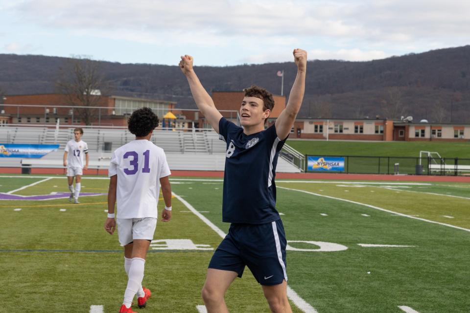 Beacon's Brody Timm raises his fists in celebration after his team defeated Christian Brothers Academy in the New York State Class A  boys soccer semifinals on Nov. 12, 2022.