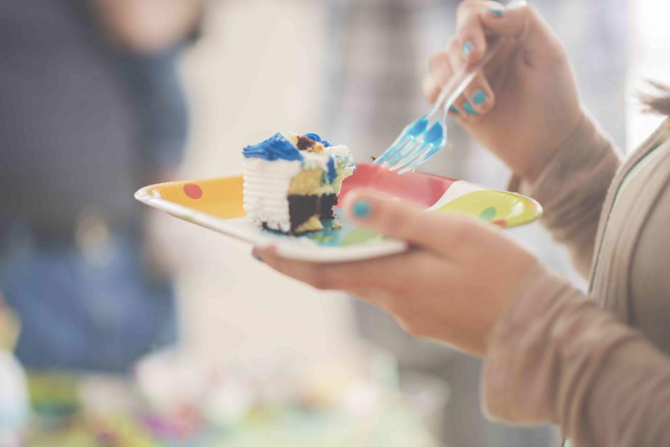 Laura Beach / Getty Images Stock image of teenage girl eating cake