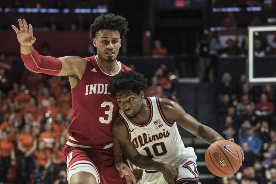Illinois' Andres Feliz (10) drives past Indiana defender Justin Smith (3) in the first half of an NCAA college basketball game Sunday, March 1, 2020, in Champaign, Ill. (AP Photo/Holly Hart)