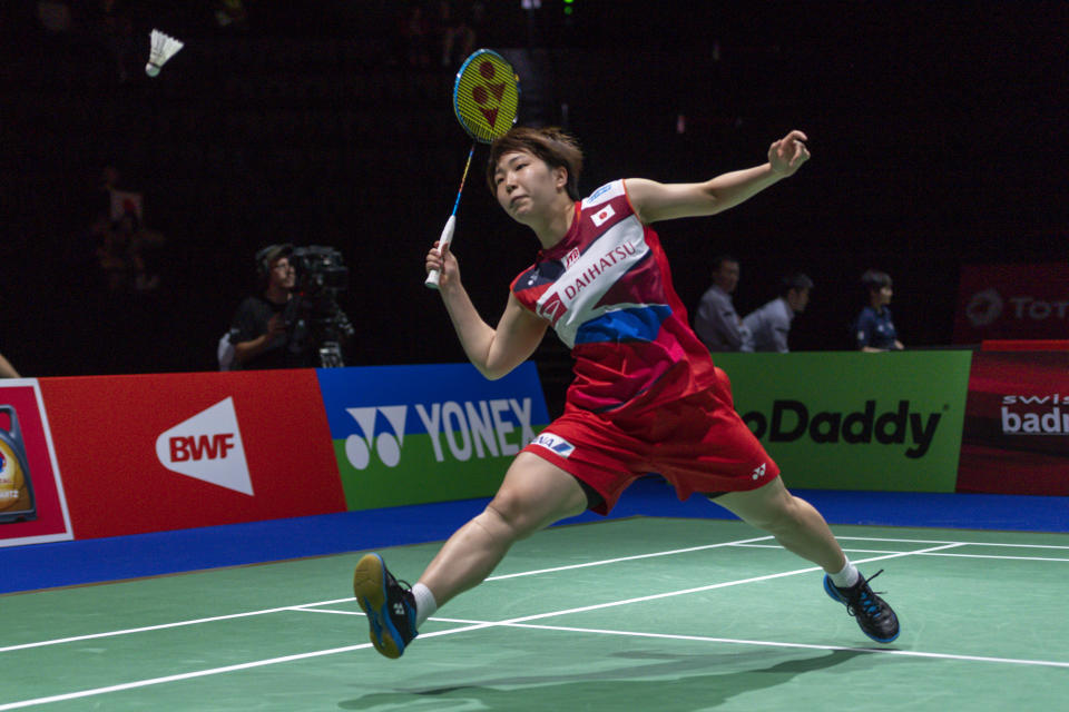 Japan's Akane Yamaguchi returns a shuttlecock to Singapore's Yeo Jia Min during their women's singles second round match at the BWF Badminton World Championships in the St. Jakobshalle in Basel, Switzerland, Tuesday, Aug. 20, 2019. (Georgios Kefalas/Keystone via AP)