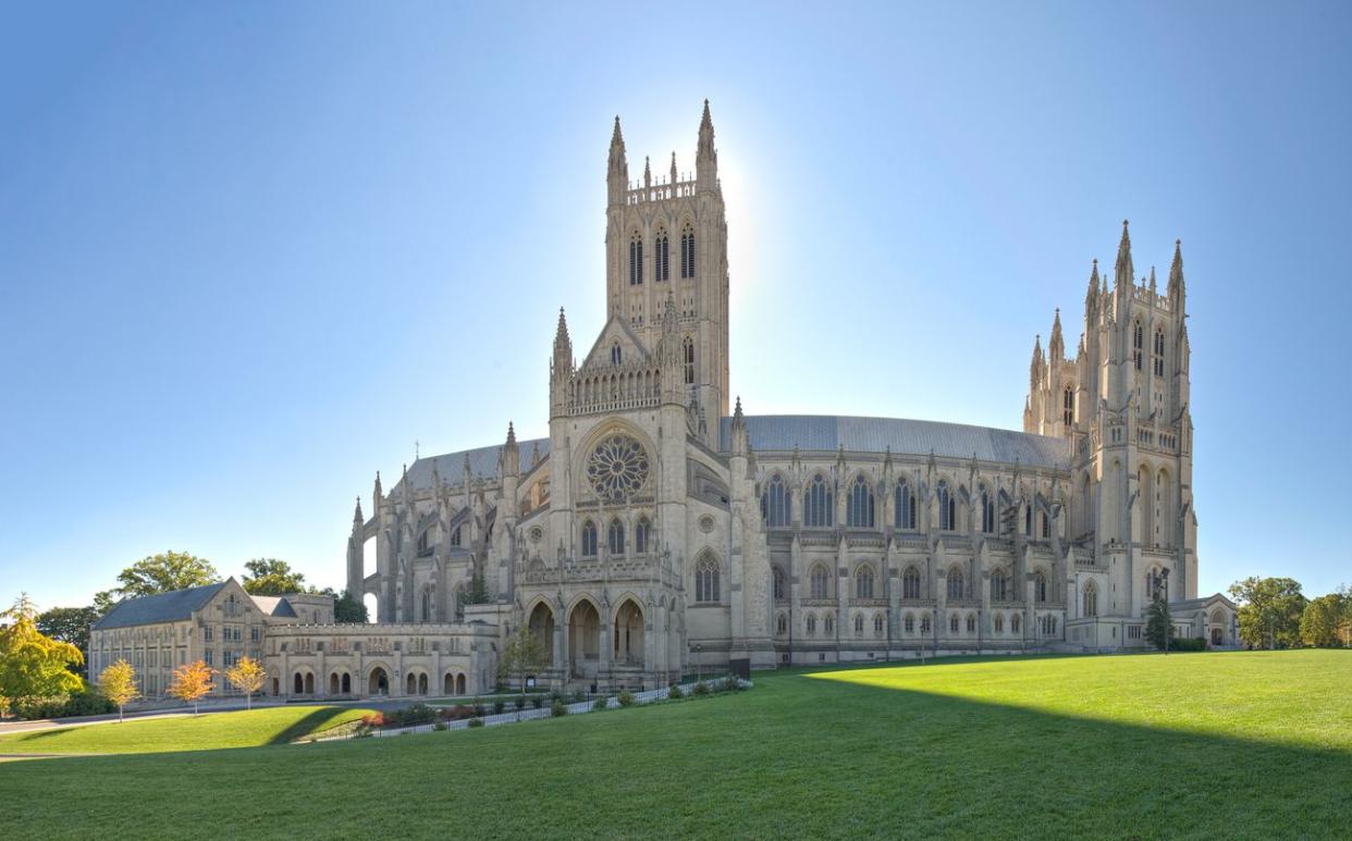 Challenging capture of a National Treasure -- Washington DC's National Cathedral. Sun glows behind the central bell tower. Captured with an archtecture lens among other imaging techniques, the entire cathedral is displayed in one frame. This is an enormou