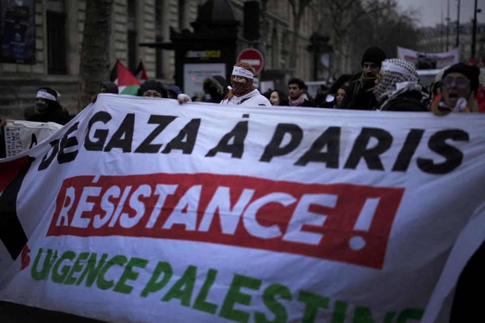 Demonstrators hold a banner reading "From Gaza to Paris. Resistance " during a pro-Palestinian rally in Paris, Saturday, Jan. 13, 2024. (AP Photo/Christophe Ena)