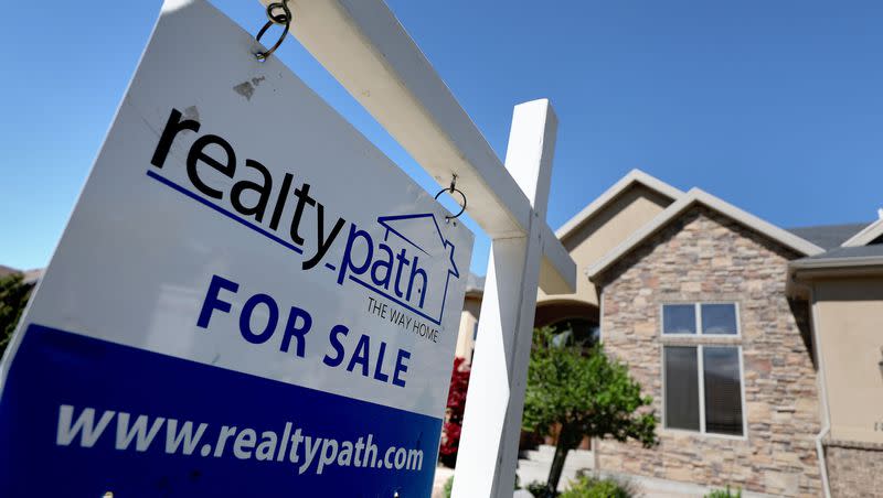 A “For Sale” sign is posted in the yard of a house in Sandy on Tuesday, May 31, 2022. Salt Lake City has the most “at-risk” housing market for a home price correction in the nation, according to a new report by Morningstar.