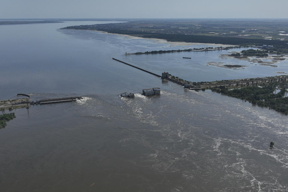 Water flows over the collapsed Kakhovka Dam in Nova Kakhovka, in Russian-occupied Ukraine, Wednesday, June 7, 2023. Russia had the means, motive and opportunity to bring down a Ukrainian dam that collapsed earlier this month while under Russian control, according to exclusive drone photos and information obtained by The Associated Press. (AP Photo, File)